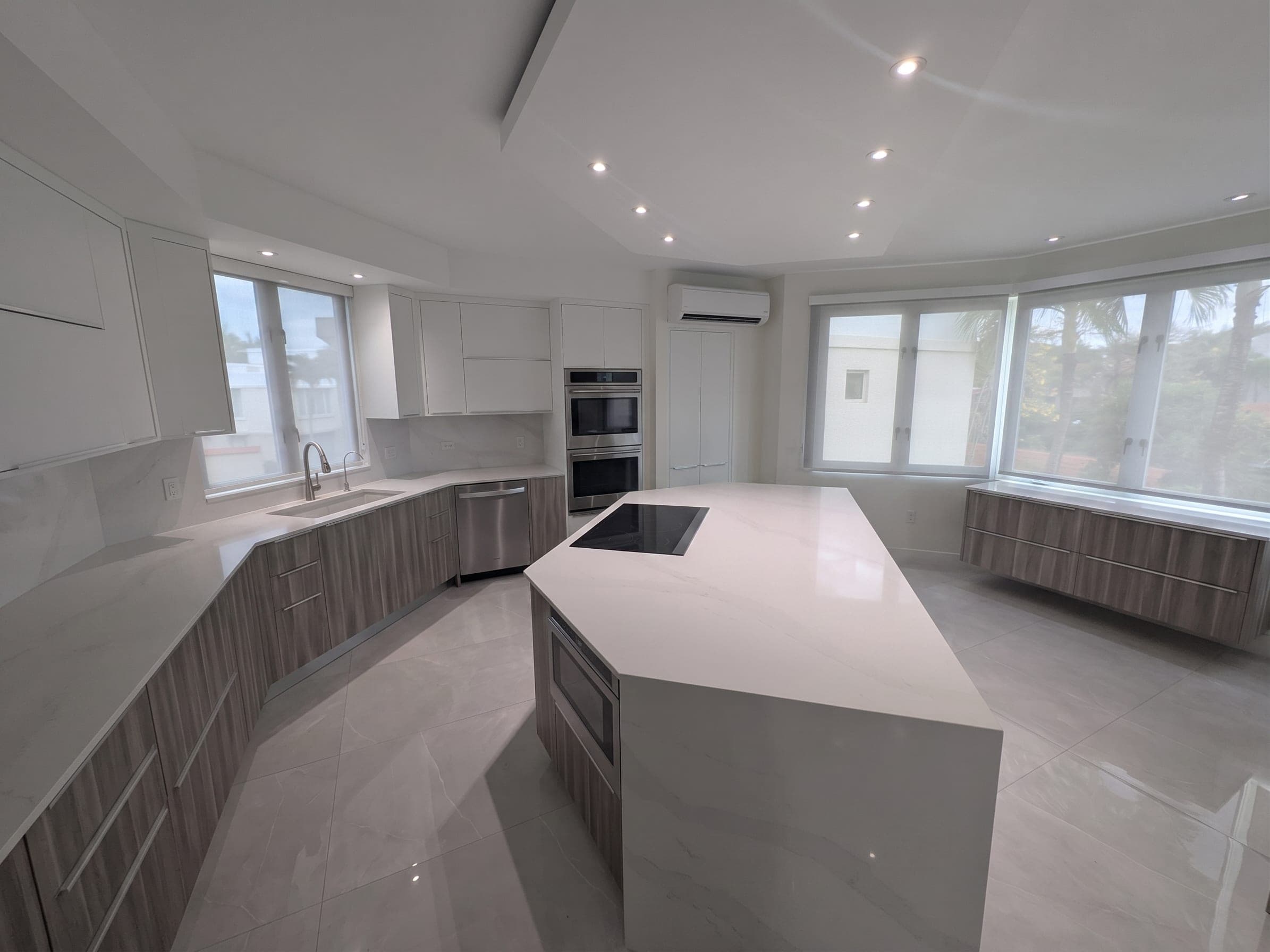 Wide view of the kitchen with double wall ovens and induction cooktop