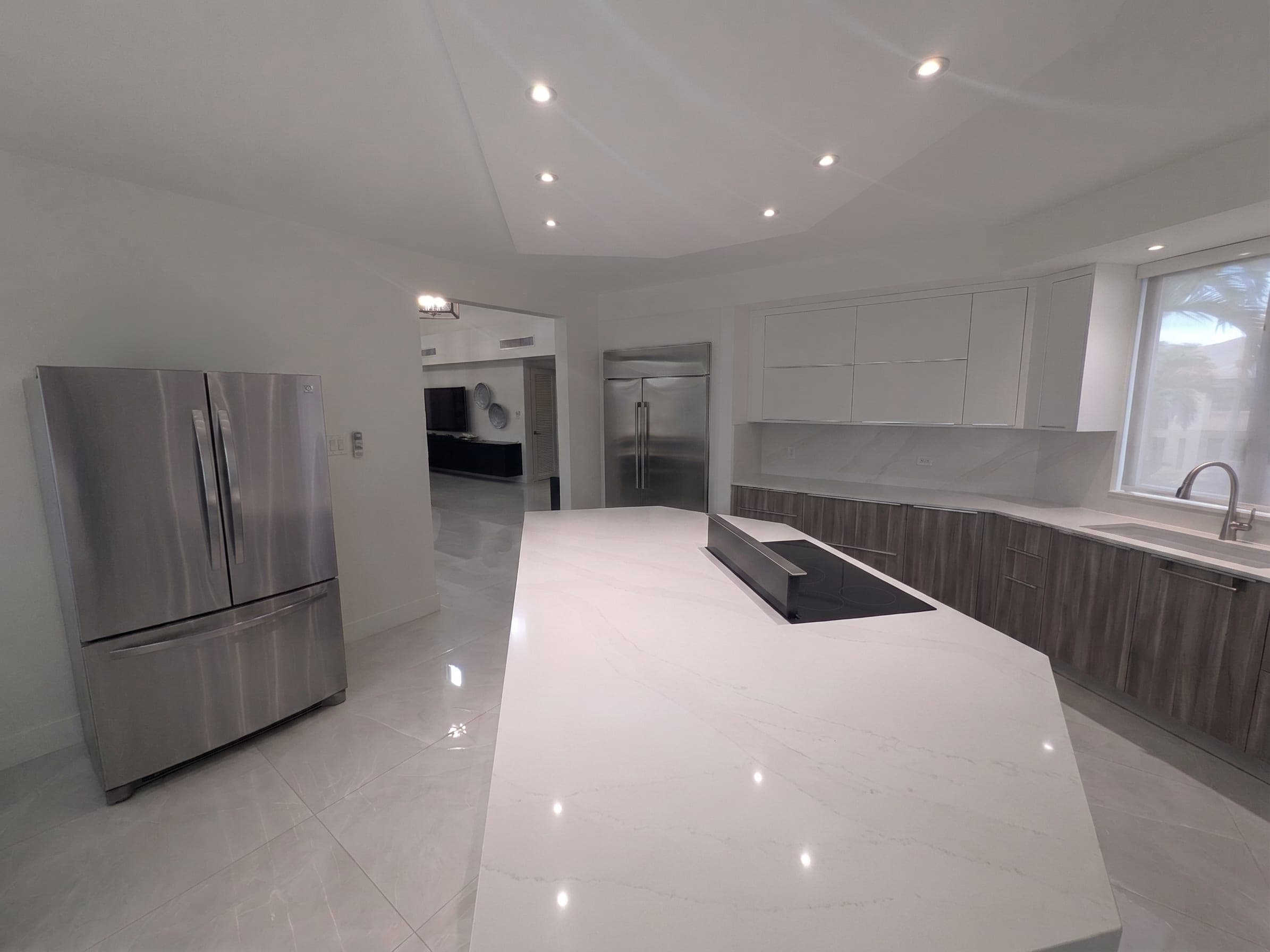 Kitchen with stainless steel refrigerator and integrated cabinetry