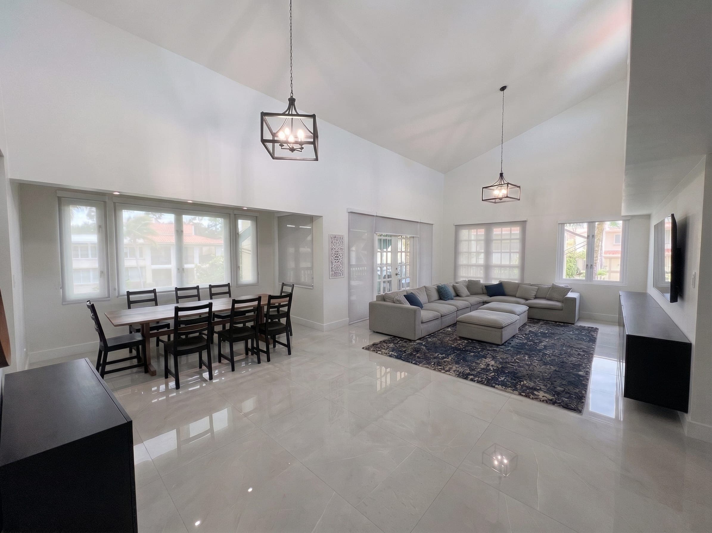 Living and dining area with 20-foot vaulted ceilings and pendant chandeliers