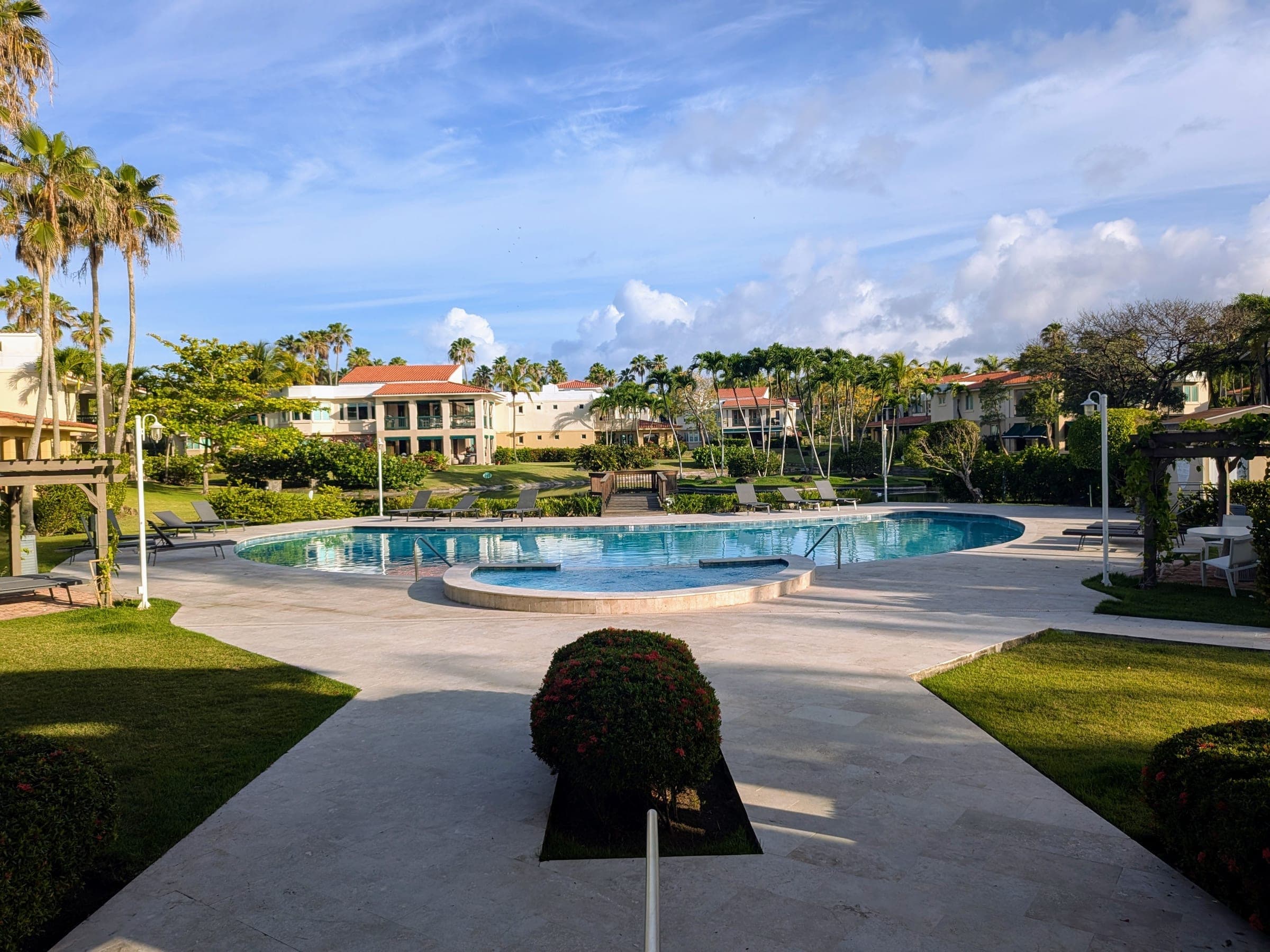 One of three community pools with stone surround and palm-lined deck