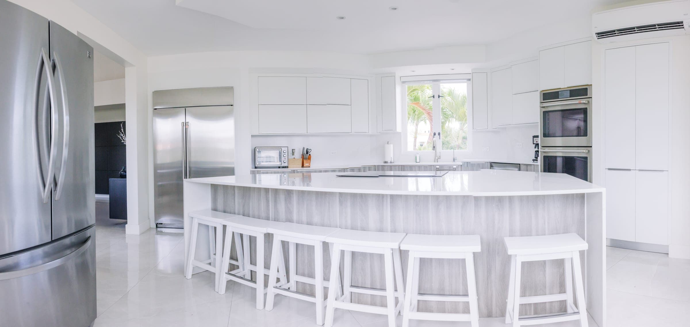 Kitchen island with waterfall quartz countertops and seating for six