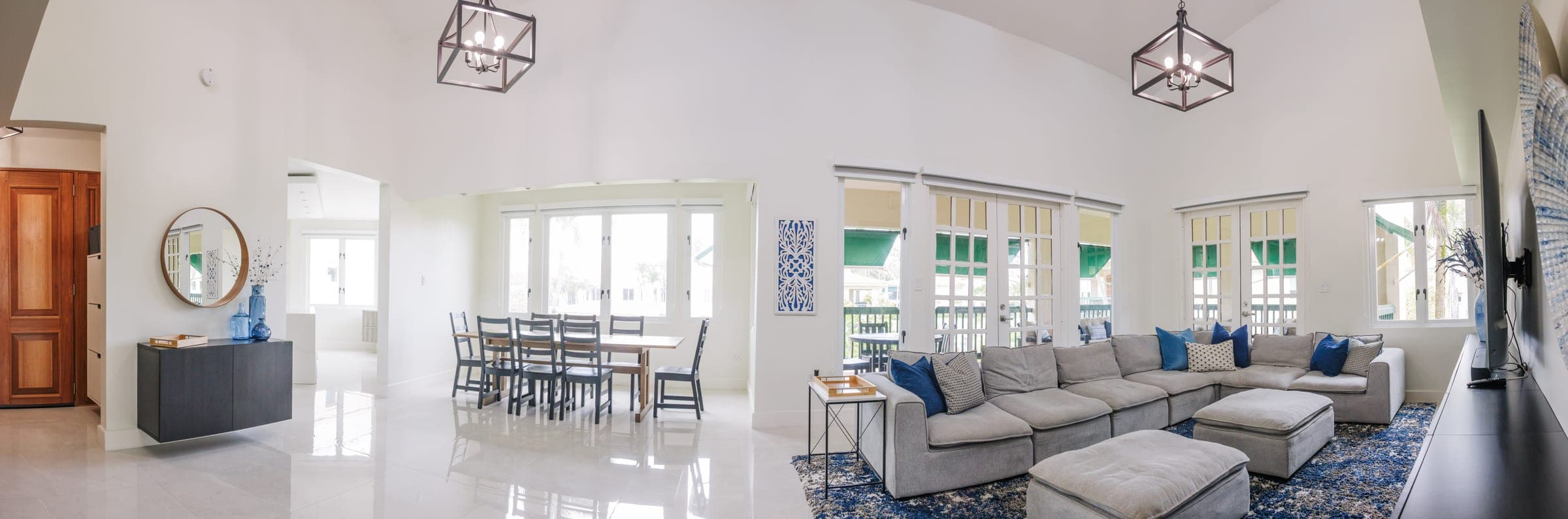 Panoramic view of the great room: living, dining, and vaulted ceilings