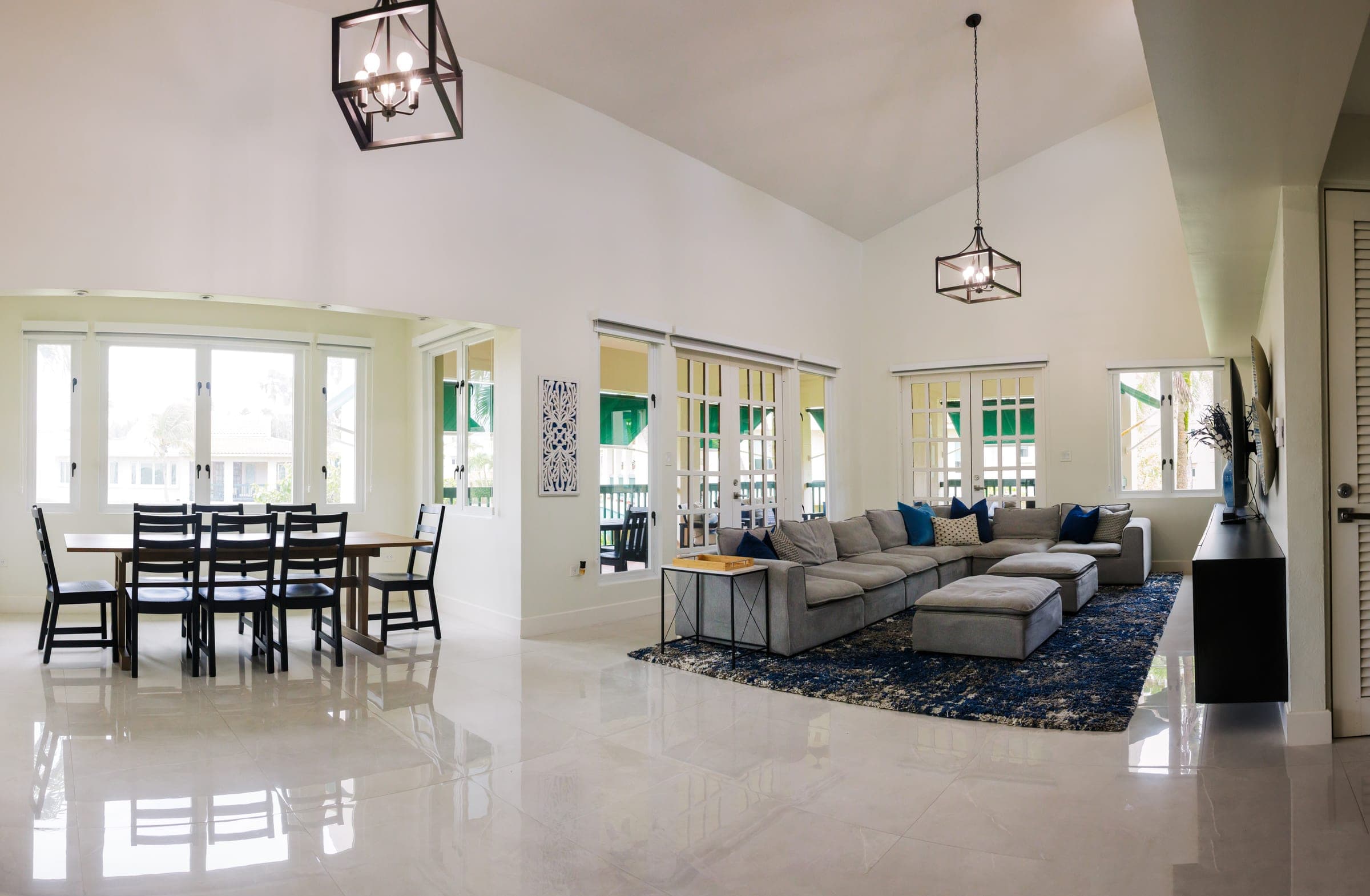 Living and dining room with 20-foot vaulted ceilings and pendant chandeliers